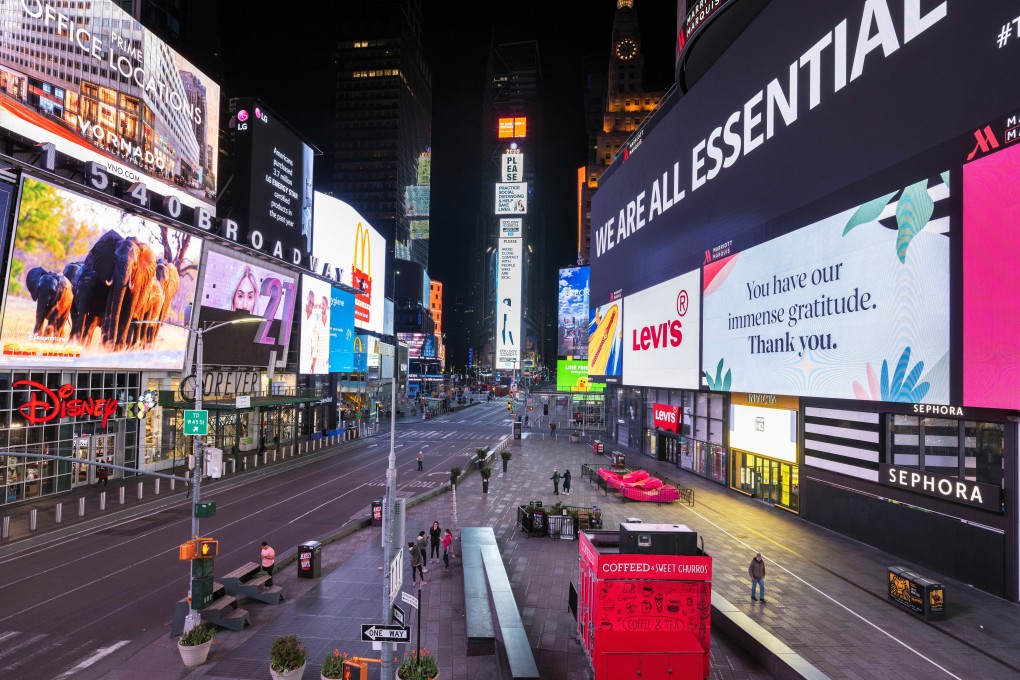 A handful of pedestrians walk through Times Square as streets remain relatively quiet due to the coronavirus outbreak in Manhattan, New York on May 5. Photo: Reuters
