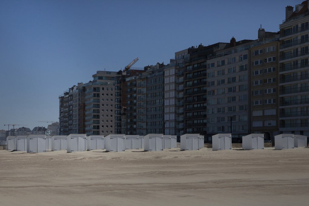 Beach changing cabins line an empty beach at the seaside town of Duinbergen, Belgium. Photo: AP Photo