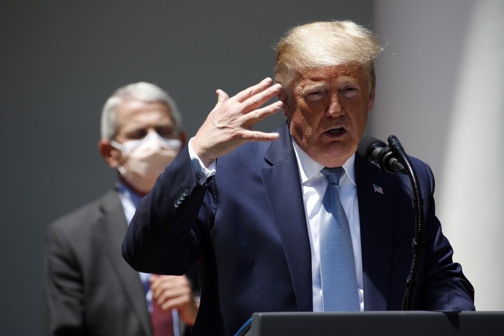 US President Donald Trump speaks about the coronavirus in the Rose Garden of the White House on Friday. Behind him is Dr Anthony Fauci, director of the National Institute of Allergy and Infectious Diseases. Photo: AP