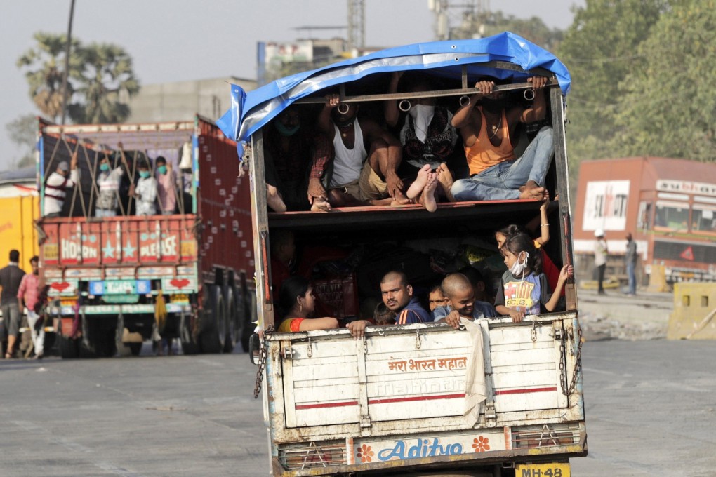 A truck carrying migrant workers leaves for Uttar Pradesh state from the outskirts of Mumbai on Thursday. Photo: AP