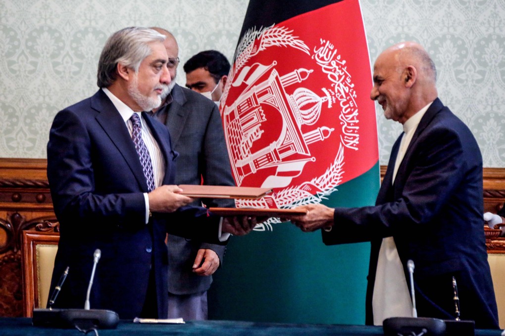 Abdullah Abdullah and Afghan President Ashraf Ghani after signing a power-sharing deal. Photo: AFP