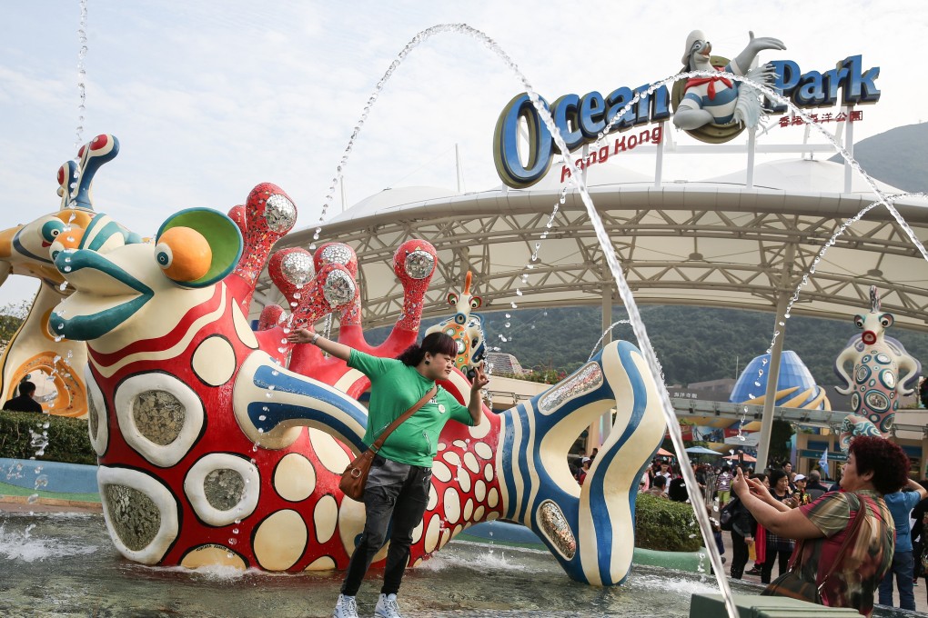 A visitor poses at the entrance to Ocean Park in December 2016. That year the part recorded a deficit of HK$241.1 million, the largest since the park ceased to be a Hong Kong Jockey Club subsidiary in 1987. Photo: Sam Tsang