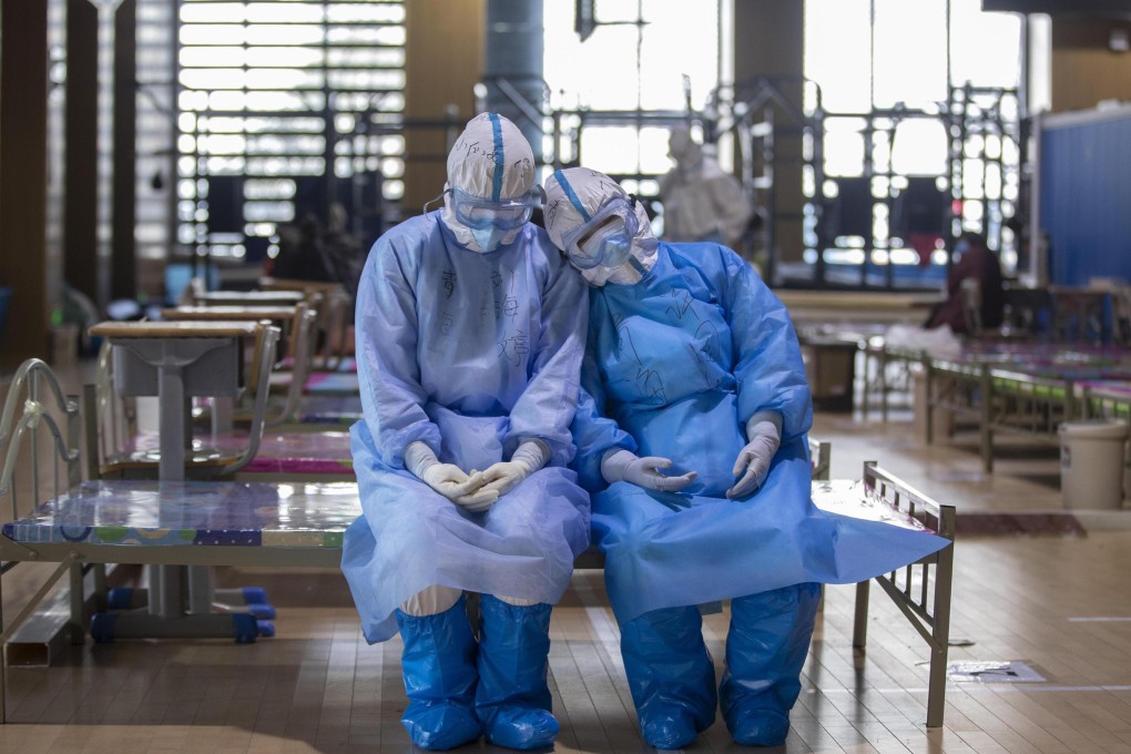 Two medical workers from northwest China’s Qinghai province take a rest before leaving the Wuchang temporary hospital in Wuhan, in central China’s Hubei province, on March 10. Photo: Xinhua