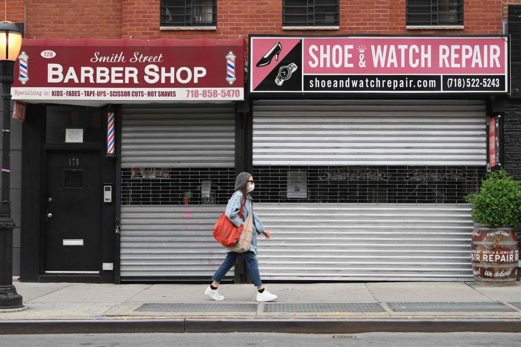 A woman walks by closed shops in Brooklyn, New York City on May 5. Photo: AFP