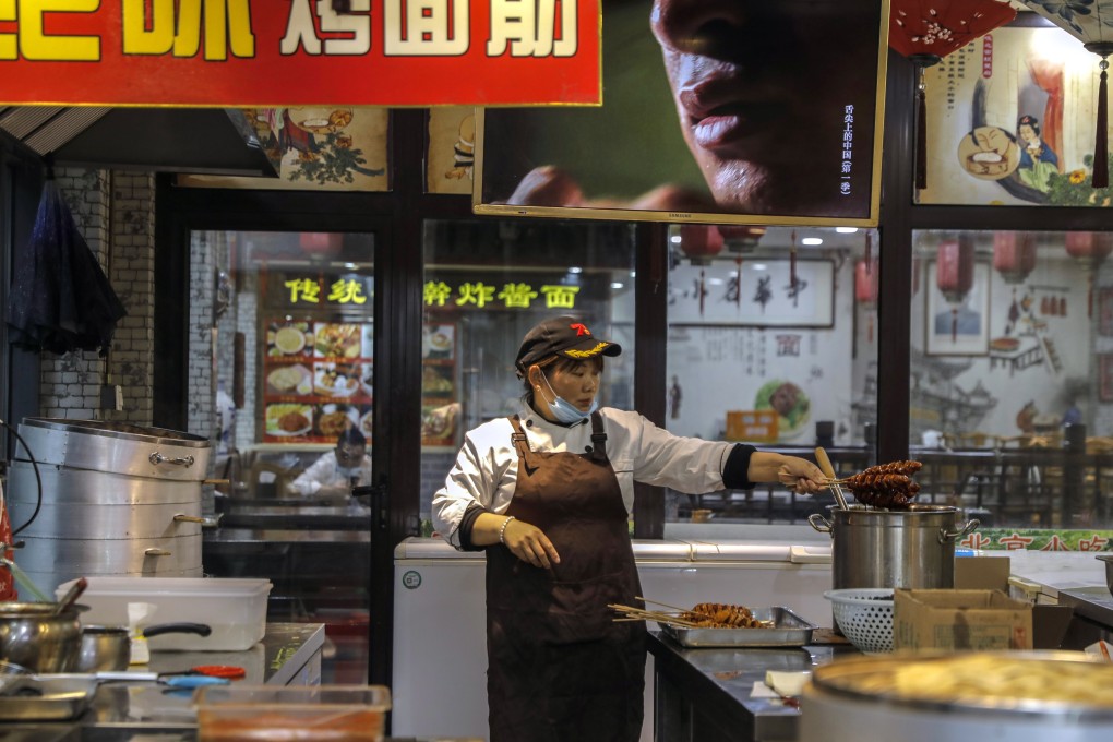 A cook works in a restaurant in Beijing. The coronavirus will transform food and beverage businesses, as economies become more digital and automated. Photo: EPA-EFE