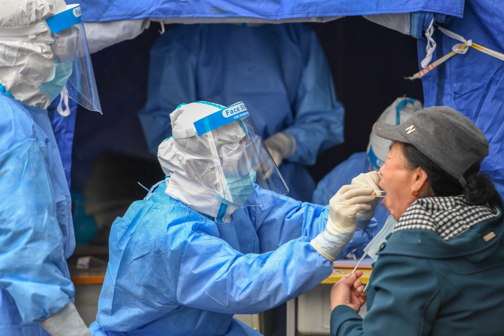 A medical worker takes a swab in Shulan, Jilin province. The city has been locked down to contain a cluster outbreak. Photo: Xinhua