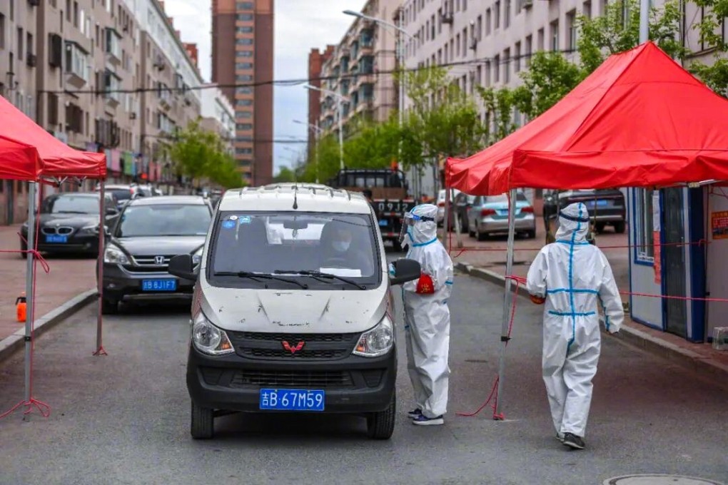 Health workers wearing protective gear check body temperatures in Shulan. Photo: Weibo