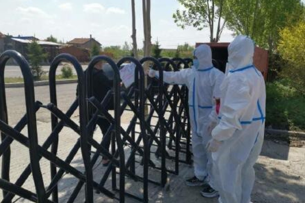 Workers make a delivery wearing protective gear in Shulan. The city in China’s northeast is now under lockdown. Photo: Handout