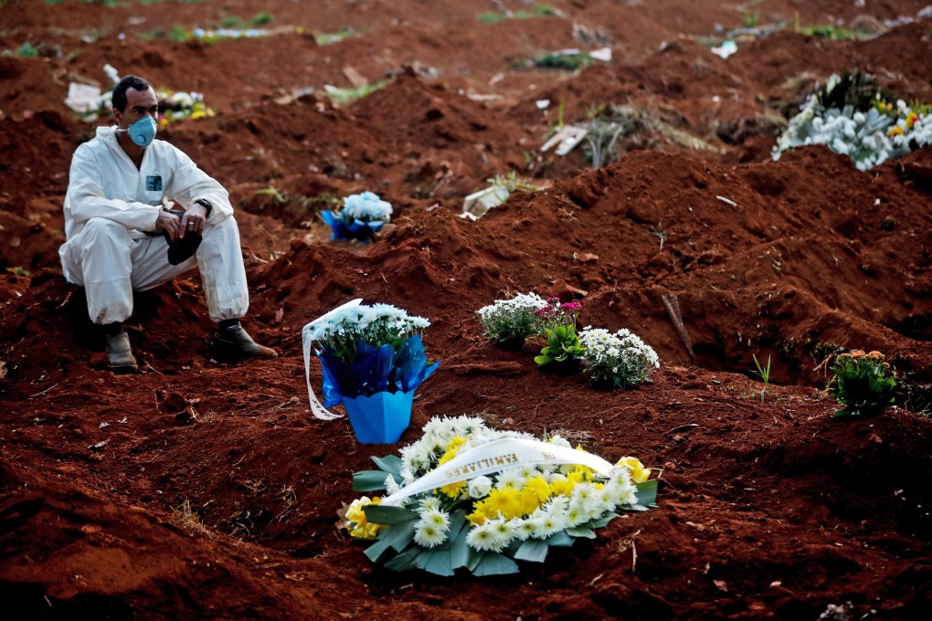 A gravedigger rests in the Vila Formosa cemetery, in Sao Paulo, Brazil. Photo: EPA