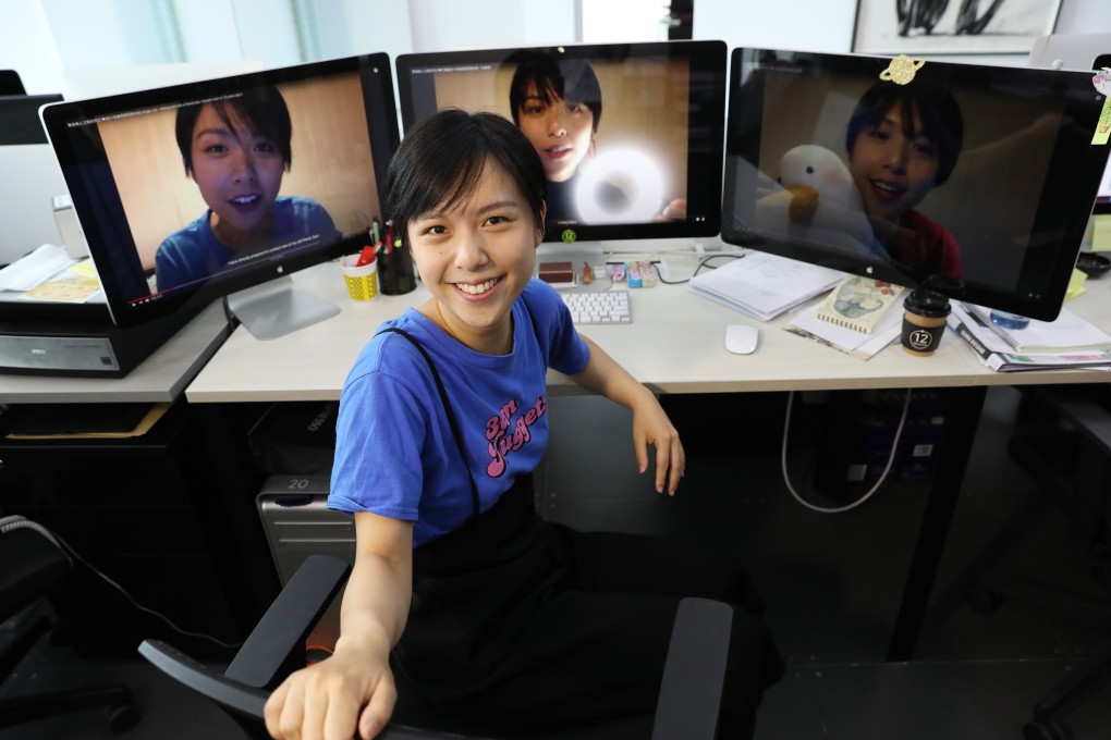 Conceptual artist and YouTuber Mak Ying-tung at the de Sarthe Gallery in Wong Chuk Hang, Hong Kong. Stills from her newest video artwork, Single Life, are displayed behind her. Photo: Nora Tam