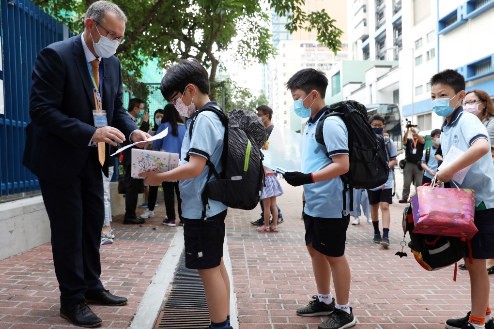 Richard Vanderpyl, the head of school at Christian Alliance International School, welcomes students back to campus on Wednesday. Photo: Nora Tam