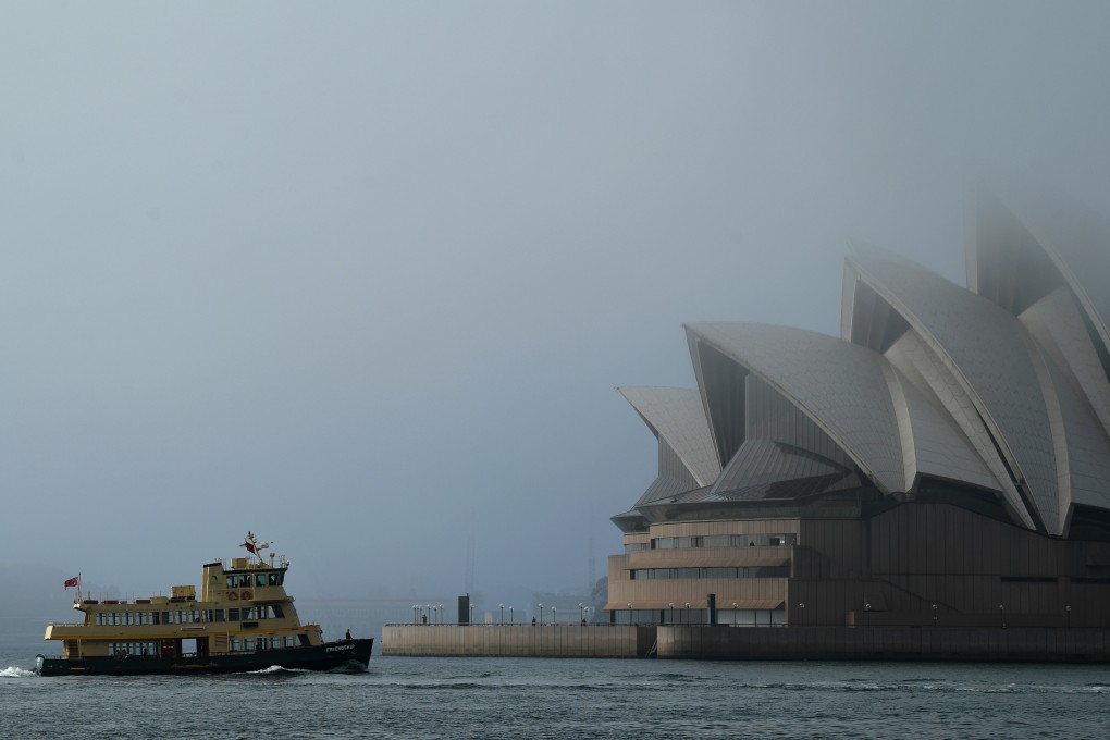 A ferry passes in front of the Sydney Opera House. Photo: DPA