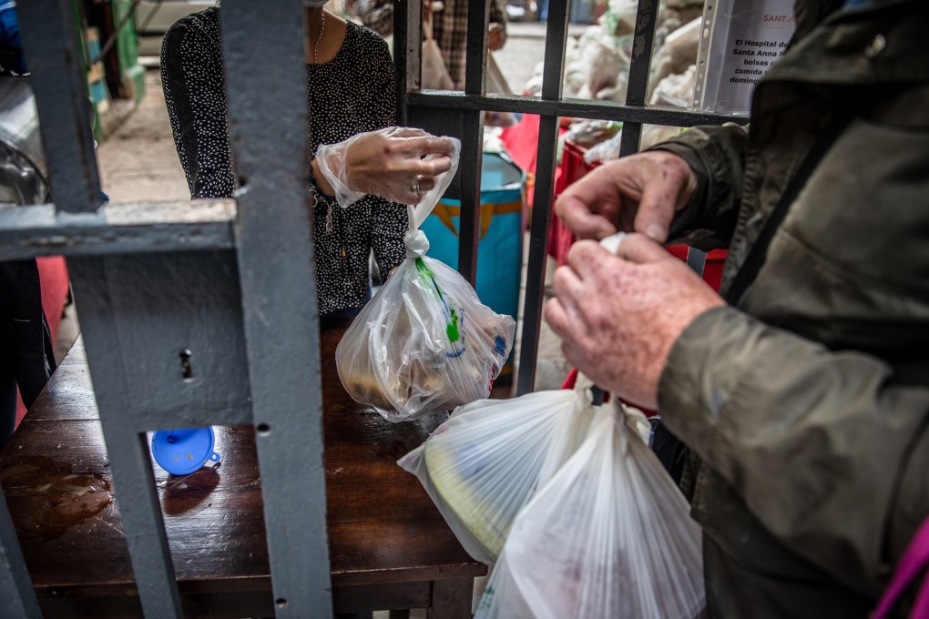 Volunteers hand out food aid parcels from a distribution point at the Santa Anna church in Barcelona, Spain, on May 17. The European Commission has forecast that the EU would see a 7.4 per cent economic contraction this year, the worst recession in its history. Photo: Bloomberg