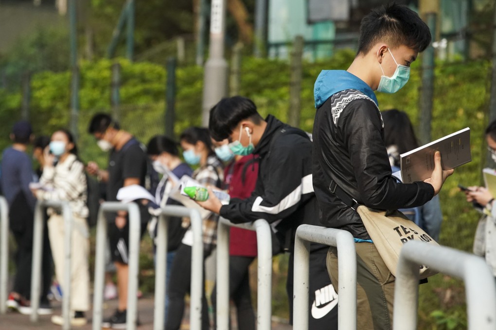 Student revise as they wait to be seated for a Diploma of Secondary Education exam, at a school in Tsuen Wan on April 27. Photo: Felix Wong