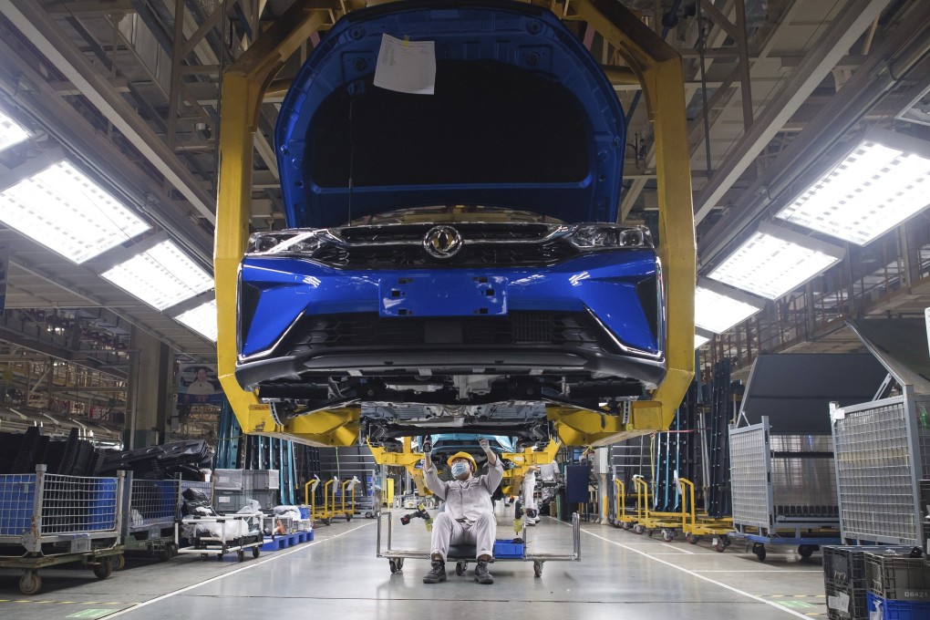 Workers labour at an assembly line for Dongfeng Passenger Vehicle Company in Wuhan, in central China's Hubei Province in March 2020. While many migrant workers across China remain trapped by travel bans due to the coronavirus, some industrial production has returned to action, including in the crucial auto manufacturing industry. Photo: Xinhua