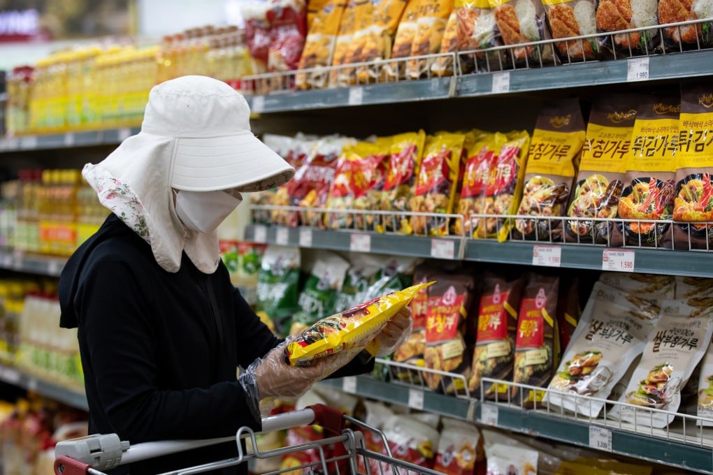 A customer wearing a protective mask and gloves at a supermarket in Seoul, South Korea. Photo: Bloomberg