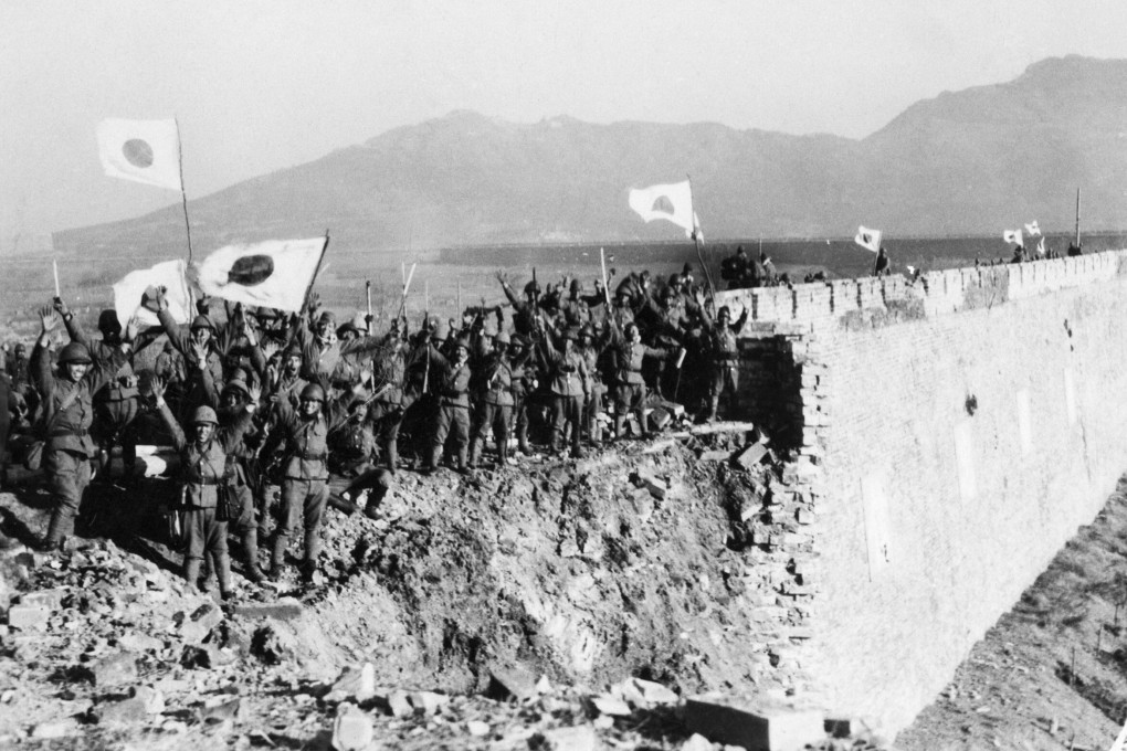 Japanese troops, grouped on the shell-torn wall around Nanking, cheer as the Chinese capital surrenders in 1938. Photo: Bettmann Archive