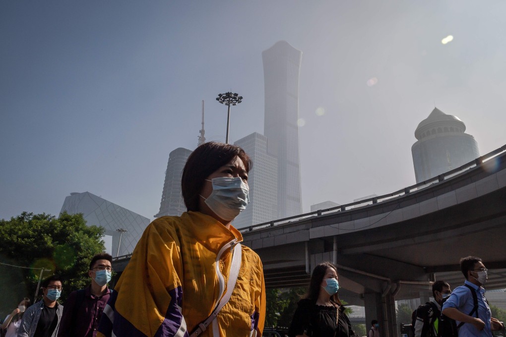 People commute during the morning rush hour before the opening session of the National People’s Congress in Beijing. Photo: AFP