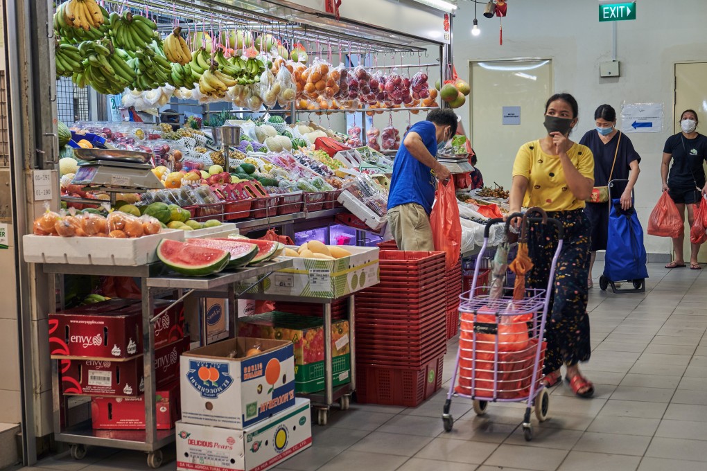 Customers shop at a market in Singapore on May 20, 2020. Photo: Bloomberg