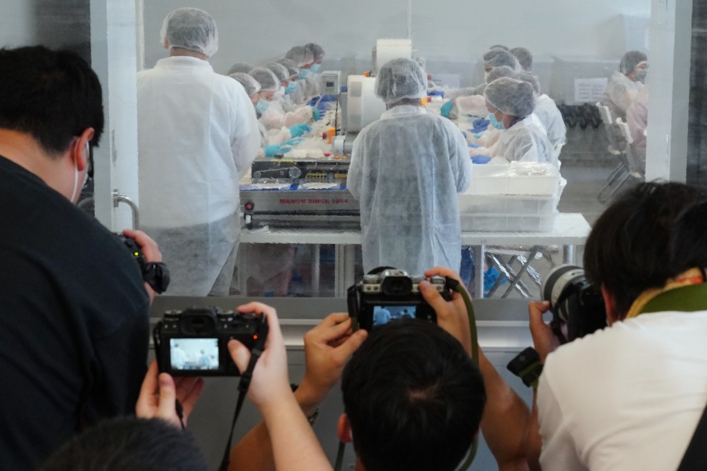 A media tour of Novetex Textiles in Tai Po, Hong Kong, gives photojournalists a glimpse of the production of CuMask+. Most of the masks are being made at a facility in Vietnam, while the the rest are assembled, disinfected and packed at three local facilities, including Novetex Textiles. Photo: Robert Ng