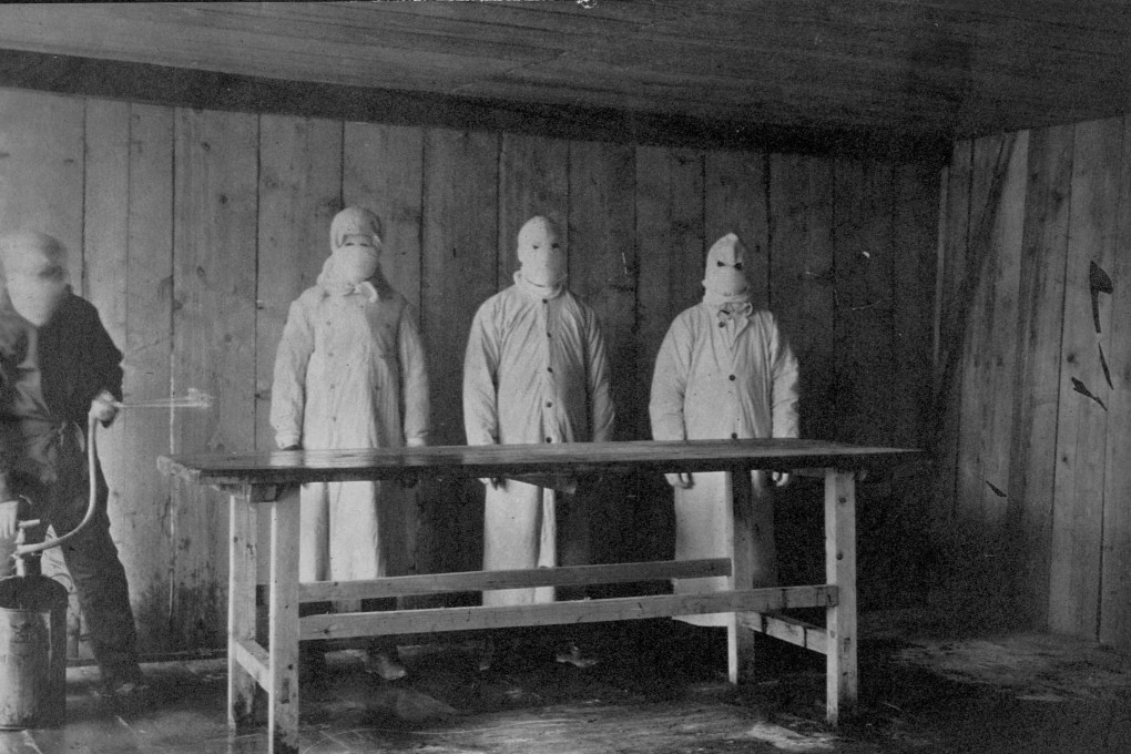 Men in protective clothing watch as a hospital assistant disinfects an autopsy table with carbolic spray at the Plague Hospital in Mukden, China, during the pneumonic plague epidemic in the winter of 1910-1911. Photo: Getty Images