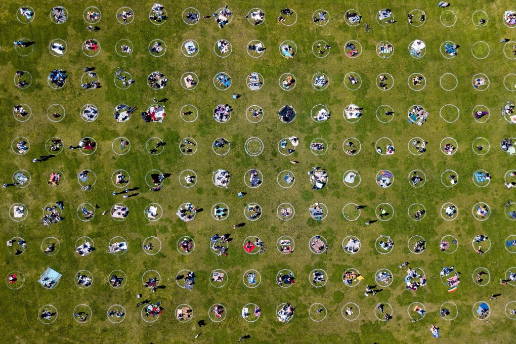 People gather inside painted circles on the grass Dolores Park in San Francisco that encourage social distancing. Photo: AFP