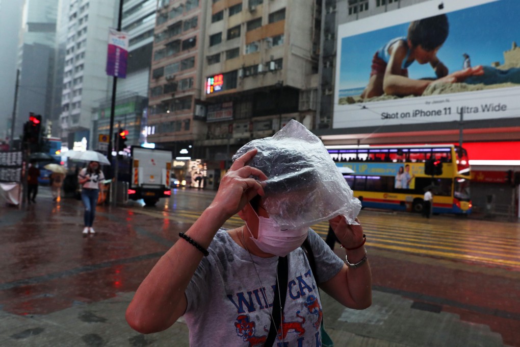 People run for shelter after getting caught in the storm in Causeway Bay. Photo: Nora Tam