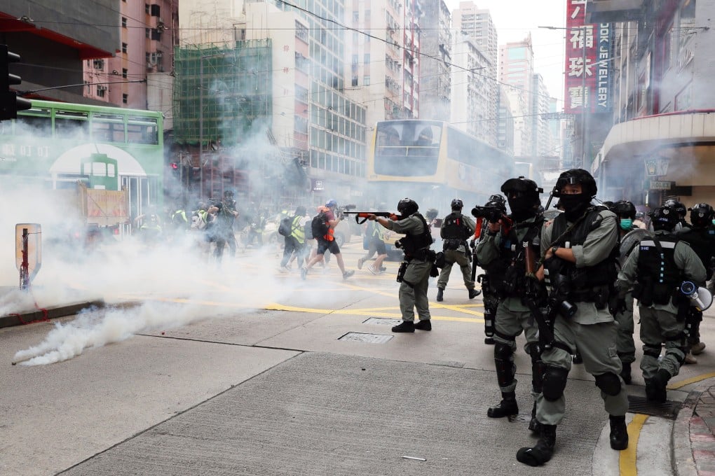 Riot police fire tear gas at the junction of Hennessy Road and Percival Street. Photo: Sam Tsang
