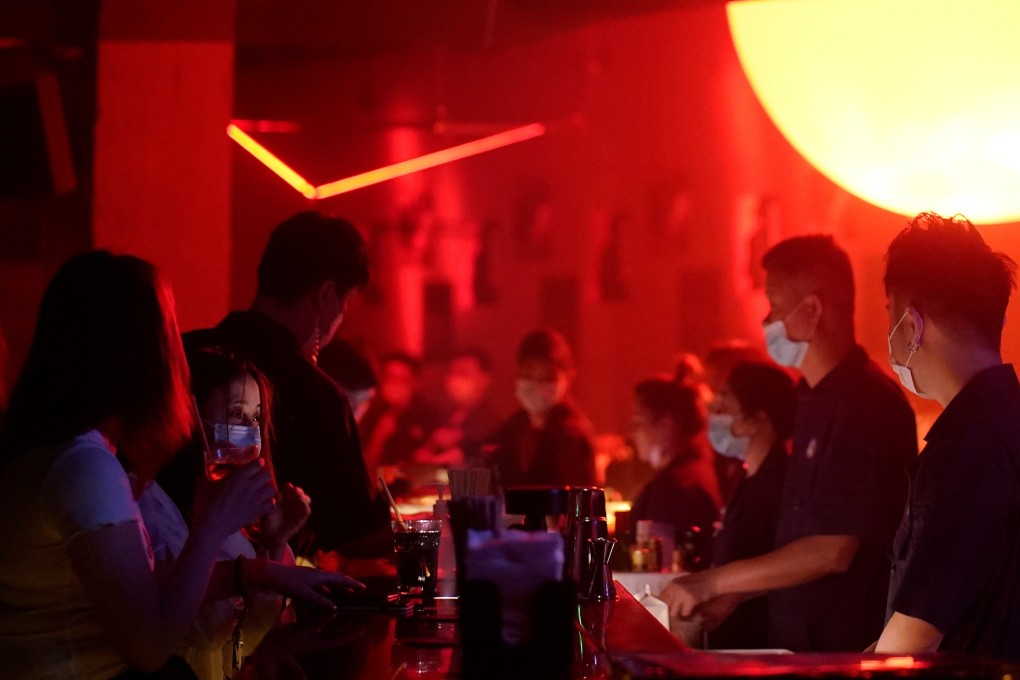 People wear face masks at a nightclub this month after it reopens in Shanghai. Photo: Reuters