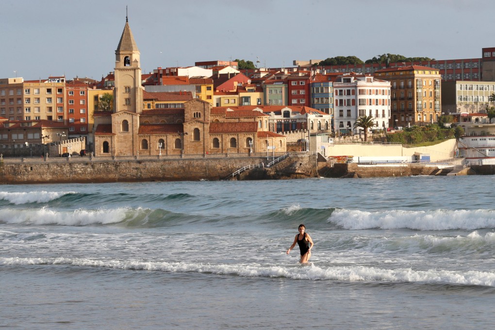 A woman enjoys San Lorenzo's beach in Gijon, Asturias, northern Spain. Photo: EPA