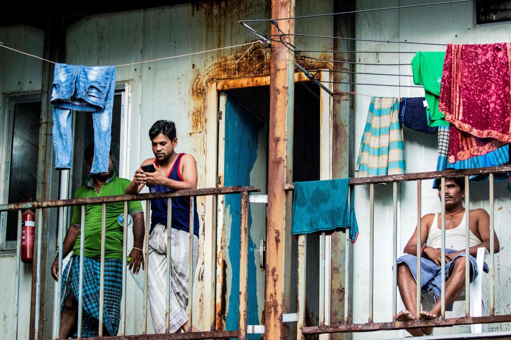 Migrant workers gather at a balcony at their living quarters in Male. Photo: AFP
