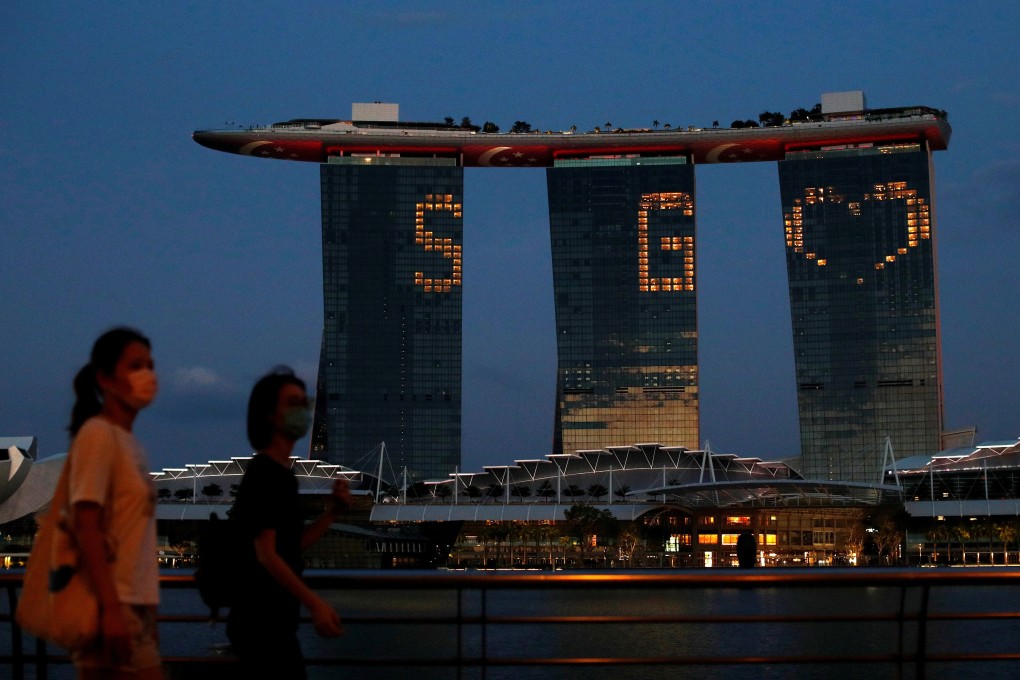 The Marina Bay Sands hotel and resort lights up in tribute to the health care workers and people staying home to curb the spread of Covid-19. Photo: Reuters