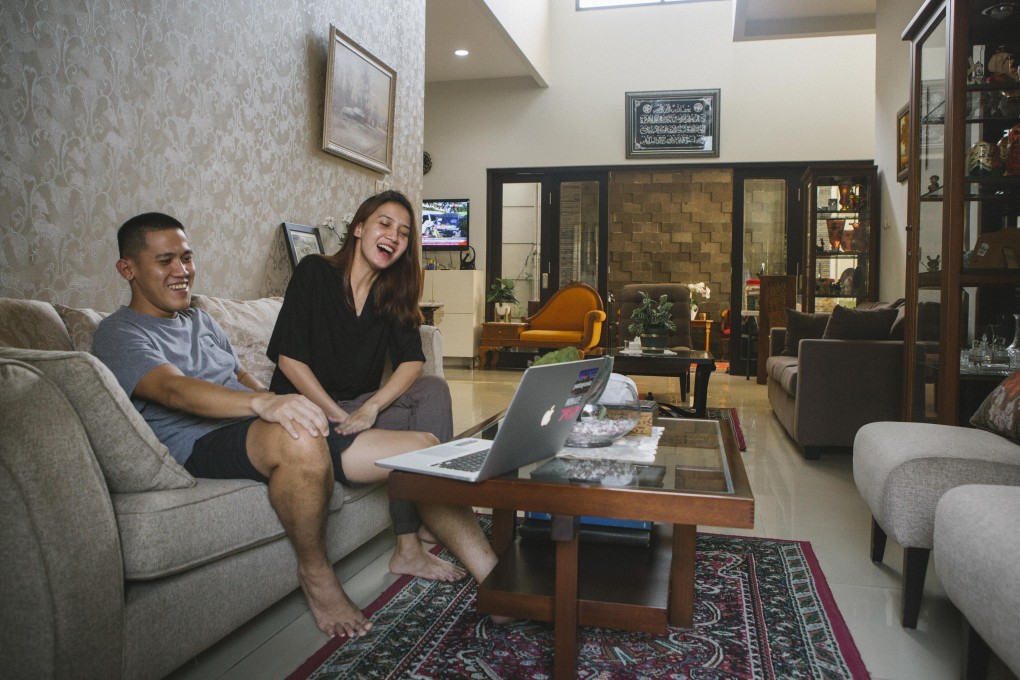 Married couple Arrie Adi Nugraha (left) and Arien Karina watch the ending of the Korean drama The World of the Married. K-dramas were already popular in Indonesia, but lockdowns have seen even more people become addicted to them. Photo: Agoes Rudianto