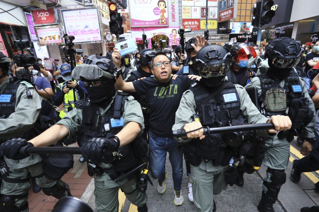 People Power activist Tam Tak-chi (centre) was arrested near Sogo department store in Causeway Bay. Photo: May Tse
