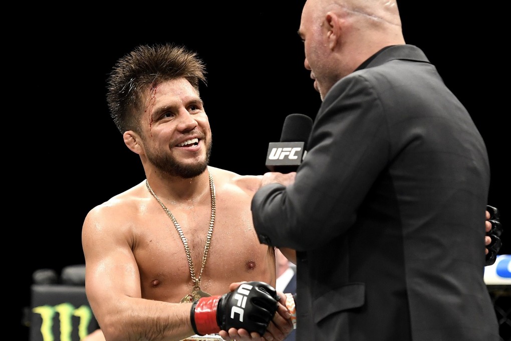 Henry Cejudo shakes hands with UFC analyst Joe Rogan after defending his bantamweight title against Dominick Cruz at UFC 249 at the VyStar Veterans Memorial Arena in Jacksonville, Florida in May. Photo: AFP