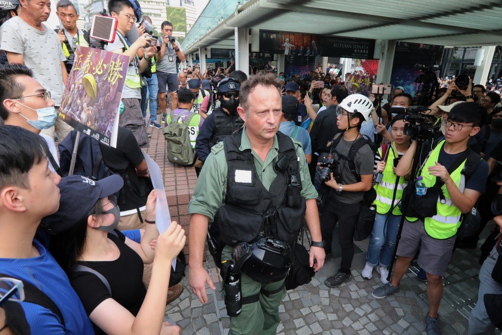 The licence holder of a property linked with assistant police commissioner Rupert Dover (centre) has been told to rectify the breaches identified by a government probe. Photo: Felix Wong