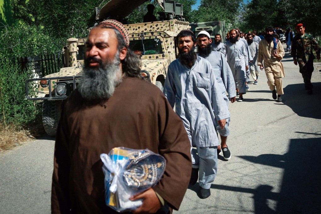 Taliban prisoners walk in line during their release from Bagram prison in Parwan province, Afghanistan on Tuesday. Photo: EPA-EFE
