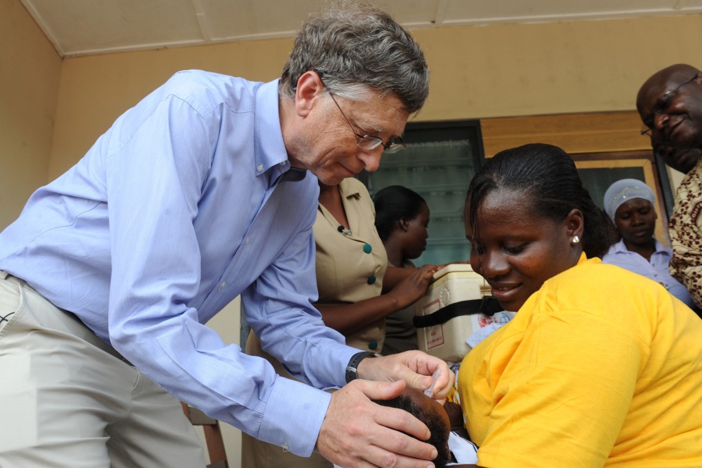 Bill Gates gives a child a rotavirus vaccine against diarrhoea in Ghana in 2013.