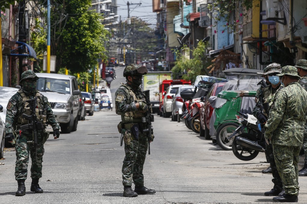 Philippine police patrol a community in Metro Manila earlier this month amid the capital’s coronavirus lockdown. Photo: EPA