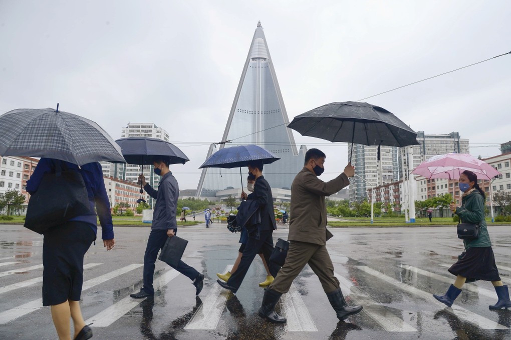 People wearing face masks walk in Pyongyang, North Korea. Photo: Reuters