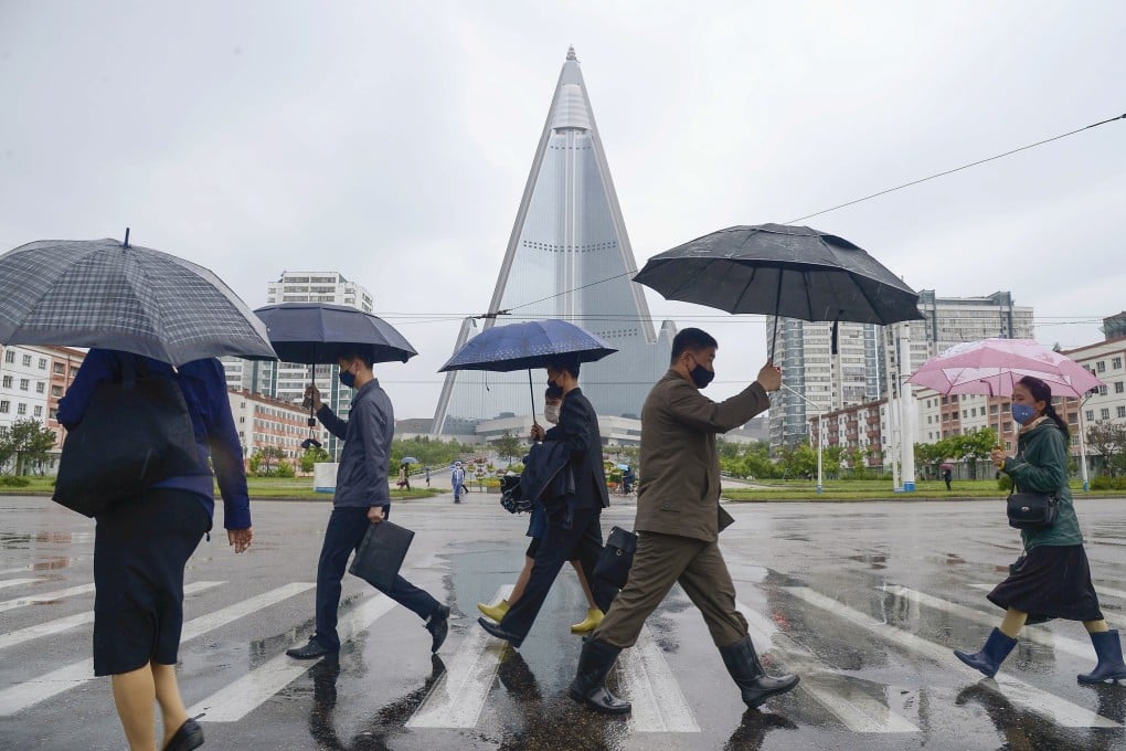 People wearing face masks walk in Pyongyang, North Korea. Photo: Reuters