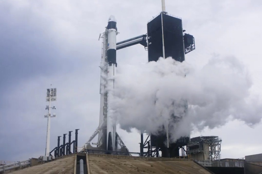 Liquid oxygen vents off the Falcon 9 rocket at the Kennedy Space Centre on Wednesday, before the mission was aborted due to weather problems. Photo: SpaceX via AP