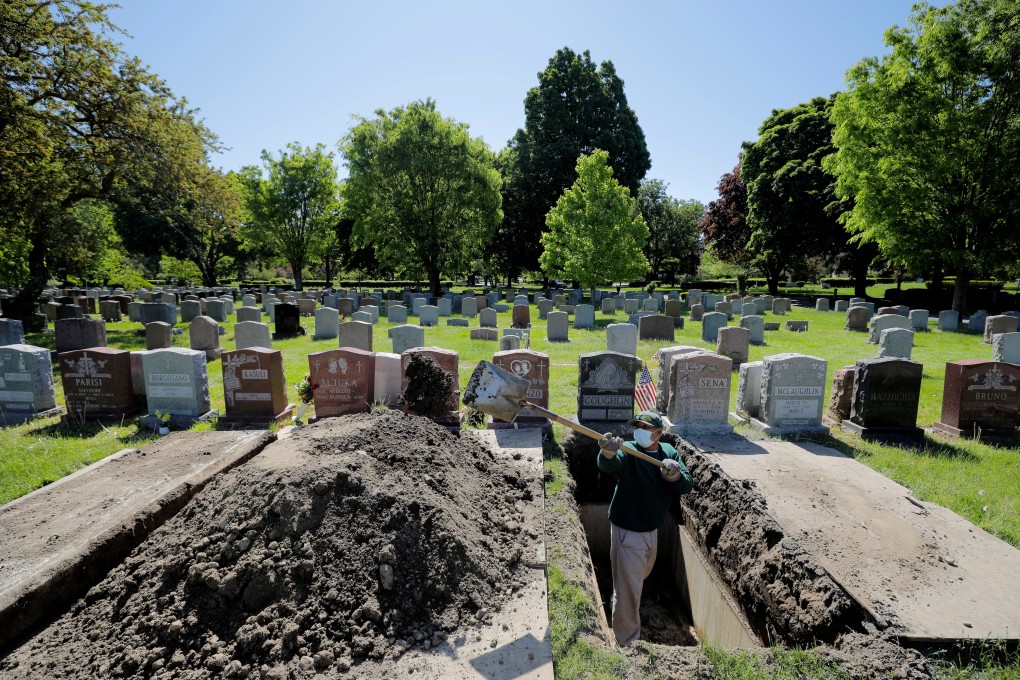 A worker prepares a grave for burial at Woodlawn Cemetery in Everett, Massachusetts, on Wednesday. Photo: Reuters
