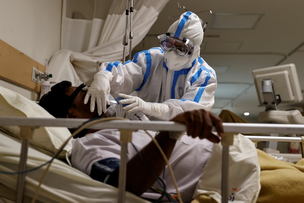 A medical worker wearing personal protective equipment takes care of a patient suffering from Covid-19, in the intensive care unit of a hospital in New Delhi. India’s coronavirus death toll has climbed past that of China. Photo: Reuters