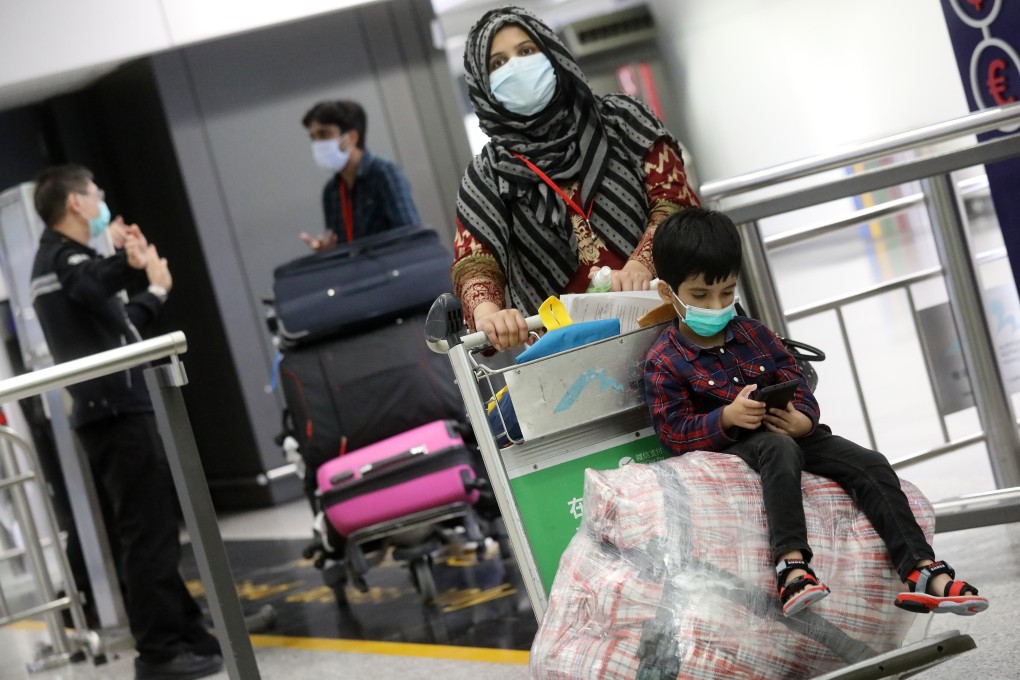 Hong Kong residents returning from Pakistan walk through the airport on April 30. Many were unhappy to be sent to a quarantine centre for 14 days. Photo: K.Y. Cheng