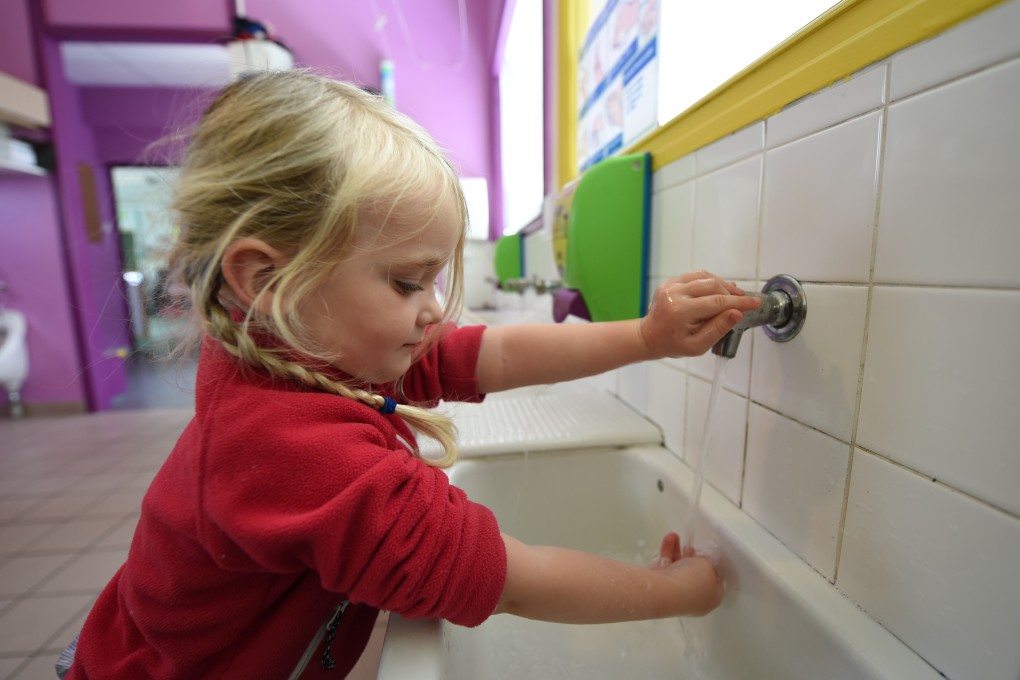 A girl washes her hands at the Alix de Bretagne school in Saint-Aubin-du-Cormier, France, on May 7. The response to the Spanish flu outbreak in the early 20th century highlighted the importance of handwashing, and the lessons from that outbreak could provide a road map for living and dealing with Covid-19. Photo: AFP
