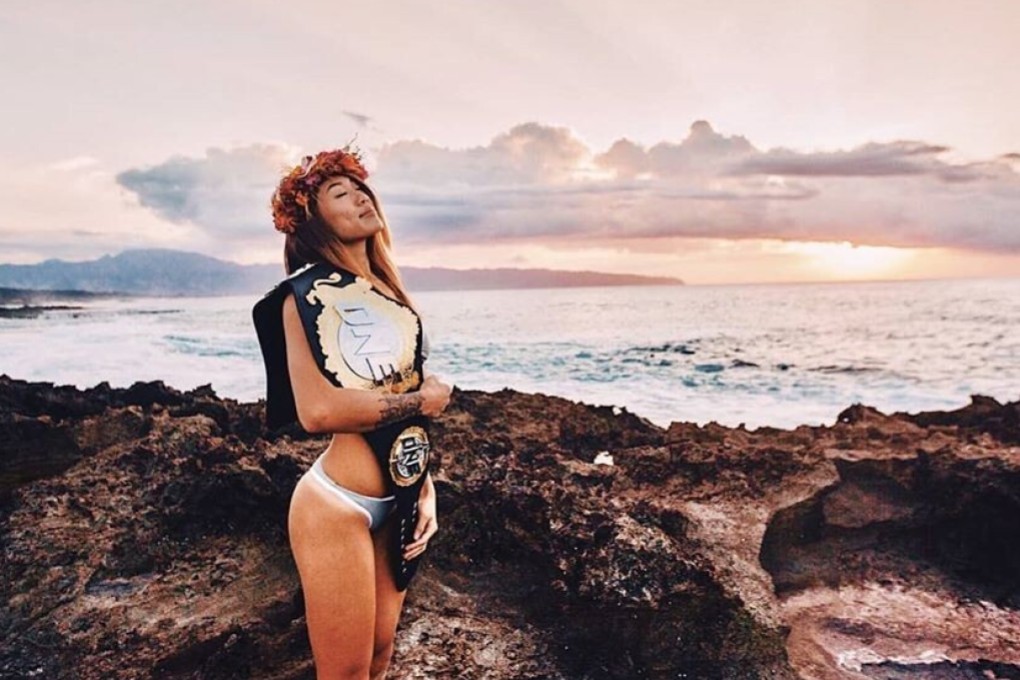 Angela Lee poses with her ONE Championship atomweight belt on the beach in Hawaii. Photo: Instagram