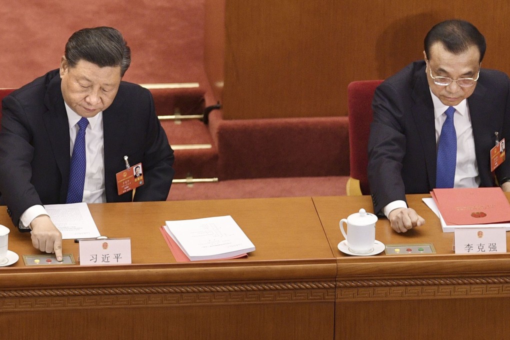 Chinese President Xi Jinping (left) and Premier Li Keqiang vote on the proposed introduction of the national security law in Hong Kong during the closing session of the National People's Congress in Beijing on Thursday. Photo: Kyodo