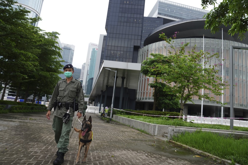 A policeman patrols with his dog outside the Legislative Council on May 26, a day ahead of a major protest organised against Beijing's planned national security law. Photo: Sam Tsang
