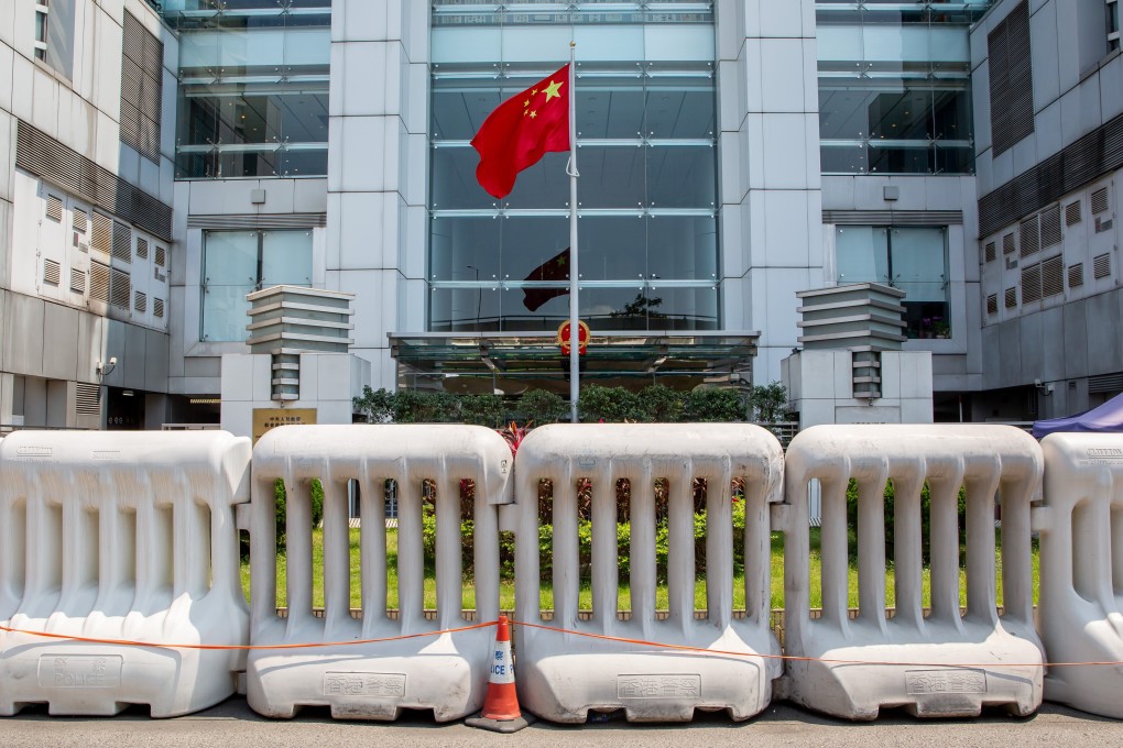 The Chinese flag flies behind water barriers outside the central government’s liaison office in Hong Kong’s Sai Ying Pun district. Photo: Bloomberg
